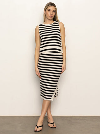 an effortlessly cool black and cream striped sleeveless top worn with a matching skirt