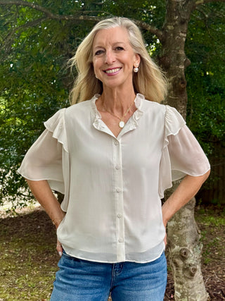 cream lightweight button down blouse with short sleeves and ruffle collar 