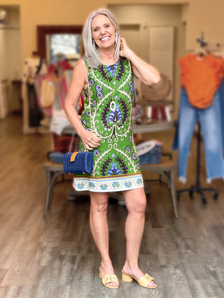 flattering above the knee shift dress in a bright green mezzo tile pattern worn with tan sandals