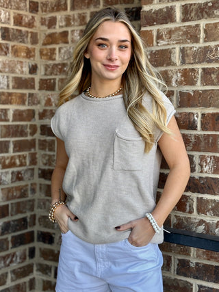 beige sleeveless knit sweater with single pocket