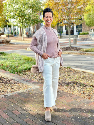 a basic mauve gray long sleeve mock neck top fitted for layering worn with white pants