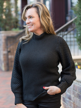 wear this black textured sweater with statement sleeves and a mock turtleneck to thanksgiving and add to your winter wardrobe