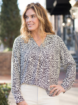 a black and white animal print blouse in a relaxed fit with long sleeves and a v neck