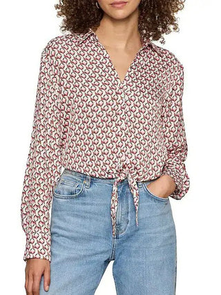 a silky long sleeve v neck collared blouse with a pink petal grid and a tie at the hem