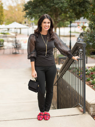 wear this black top with sheer statement sleeves to holiday and christmas parties for a chic winter look with black pants
