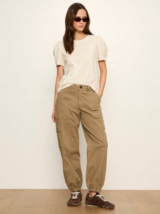 a classy pleated off white tee with short puff sleeves worn with khaki joggers