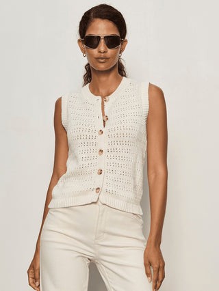 a sleeveless ivory knitted sweater vest with buttons down the front