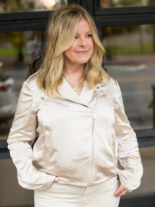 a pale gold moto jacket that hits at the hips with statement zippers perfect to brighten up cold weather days
