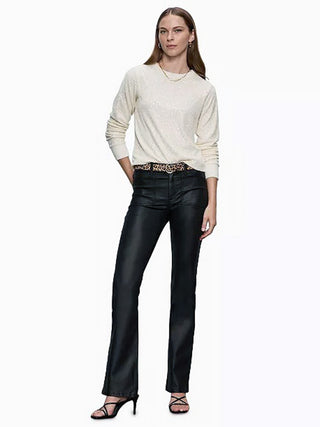 a chalk white long sleeve sequined top worn with black leather pants