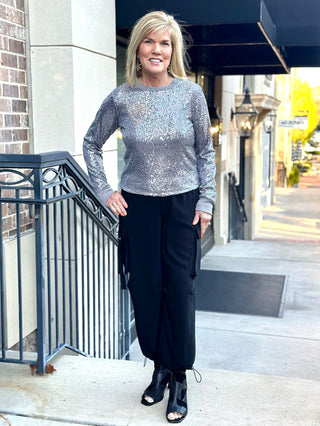 a&nbsp; fun long sleeve sparkling gunmetal sequin party blouse worn with black pants