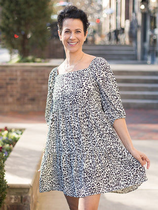 a black and white animal print mini dress with a full skirt and three quarter sleeves