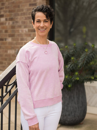a flattering soft pink long sleeve sweatshirt