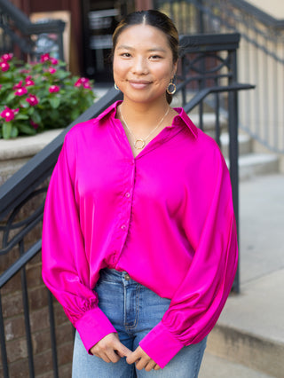 a hot pink satin blouse in a relaxed fit with dramatic sleeves