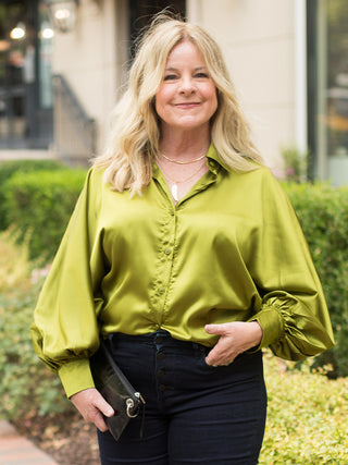 a neon green satin blouse in a relaxed fit with dramatic sleeves