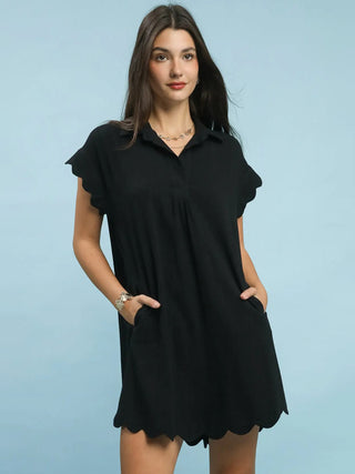 an easy going black scalloped mini dress with pockets