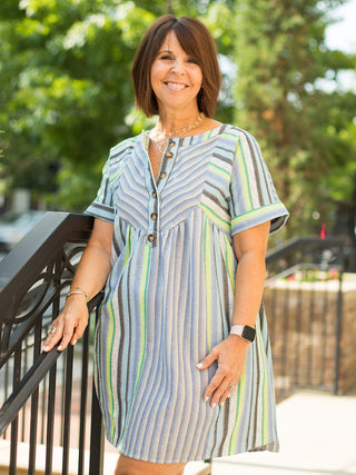 a striped button down mini dress with blue and green stripes featuring short sleeves and side pockets