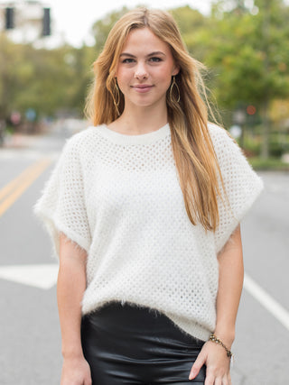 an ivory fuzzy top with drop short sleeves and an oversized fit with alluring open knit perfect for cold weather fashion 