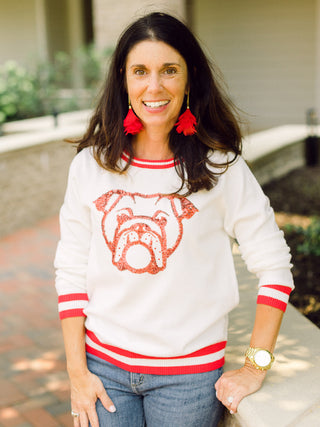 a white sweater with red trim and a sequin uga bulldog perfect for georgia football game day and tailgating style
