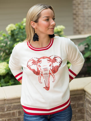 a white sweater with red trim and a sequin bama elephant perfect for alabama football game day and roll tide tailgating