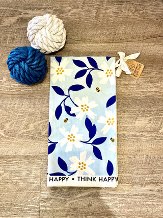 vibrant positive tea towel with a blue floral pattern and think happy vibe