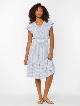 Woman wearing a blue and white striped dress on a white background
