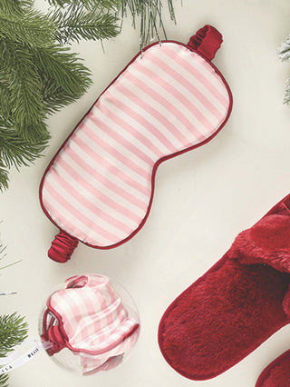 a pink and white striped sating sleeping mask gift