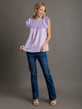 bright lavender blouse with ruffled sleeves and smocked yoke worn with blue jeans