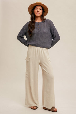 smooth natural ecru linen pants with elastic waist and drawstring paired with black sweater