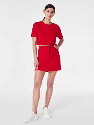 red spanx mini skort with a soft fit and drawstring waistband over inner shorts with a hidden pocket worn with matching top