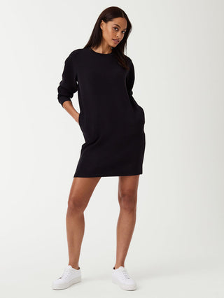 a flattering lightweight black spanx crew neck dress worn with white sneakers
