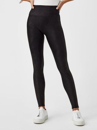 a pair of black fleece and faux leather leggings with a hight waist perfect for winter loungewear and athleisure