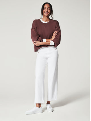 soft and flattering white cropped wide leg pants with pull on design paired with brown sweater shirt