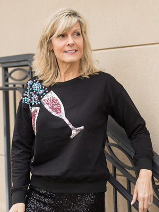 wear this black champagne sweater with bejeweled glasses and bubbles to valentines day events and cozy girls night in