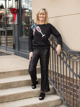 wear this black champagne sweater with bejeweled glasses and bubbles to valentines day events with sequin pants