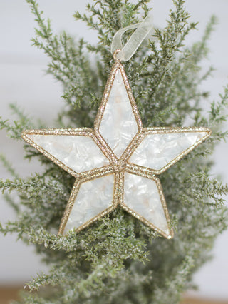 a gold glitter and white marble christmas tree ornament in the shape of a star perfect for holiday home decor and host gifts