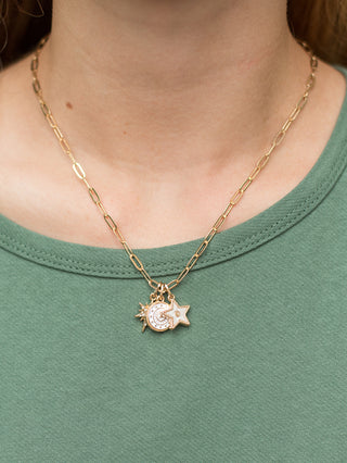 a gold necklace featuring sparkly celestial charms