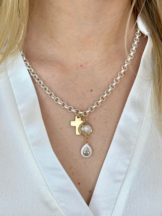 silver rolo chain with flat gold cross a white teardrop pendant with a sparkling crystal center 