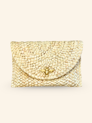 a natural beachy straw clutch handbag with a golden bee detail