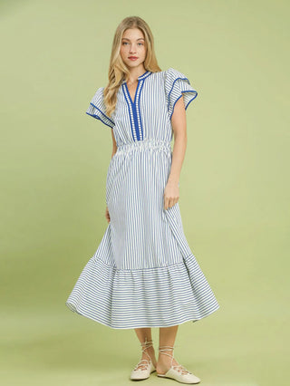 a coastal ocean blue striped midi dress with ruffled sleeves worn with white sandals
