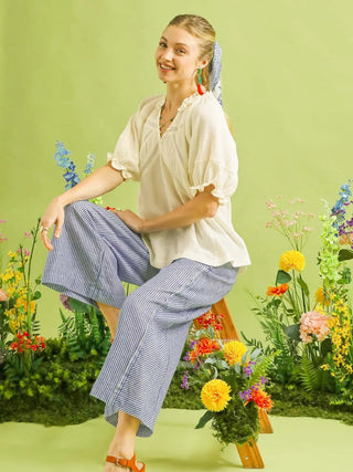 soft wide leg coastal blue striped pants with an elastic waist and front tie worn with a white top