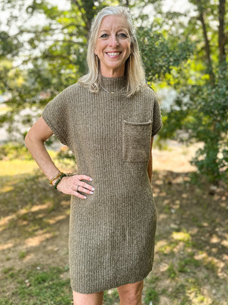 a light olive green sweater dress with short sleeves and an oversized pocket perfect for fall fashion