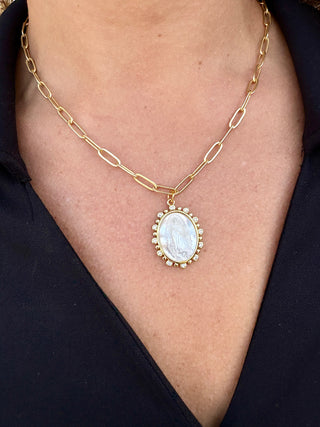 gold paperclip chain necklace with white shell mary pendant