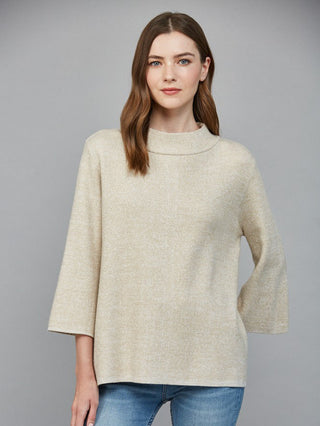 a cream and gold metallic yarn sweater with a cozy mock neck