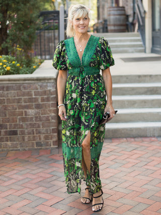 a green and black floral midi dress with puff sleeves and lace neckline perfect for wedding season and fall fashion
