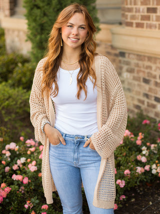 this taupe open weave knit cardigan has an open front with drop shoulder long sleeves and a knee length hem