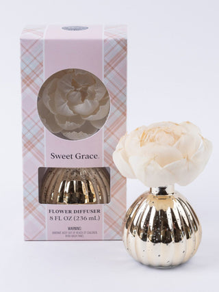 gold vase with white flower diffuser 