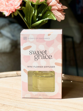 mini flower diffuser in clear jar that smells of passion fruit and sparkling tea