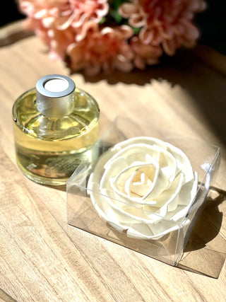 mini white flower diffuser in clear jar that smells of passion fruit and sparkling tea