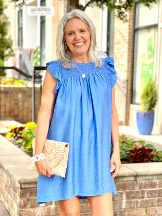 lightweight breezy blue mini dress with ruffled armholes and smocked yoke for flattering fit