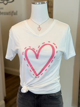 a white short sleeve tshirt with a pink heart on the chest